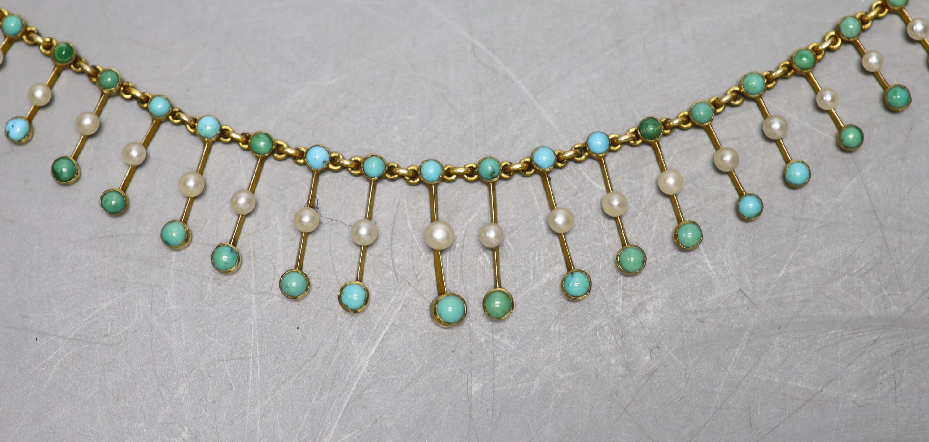 An Edwardian yellow metal, seed pearl and turquoise set fringe necklace, 42cm, gross weight 15.2 grams.